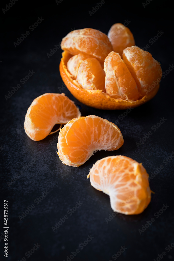 
Piece of peeled tangerine. Tangerine slices. Fruit with vitamin C