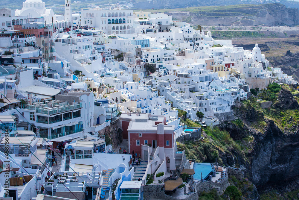 Panoramic view of Oia town cityscape at Santorini island in Greece. Traditional white houses. Greece, Aegean sea. Famous European destination Panoramic view of Oia town cityscape at Santorini island in Greece. Traditional white houses. Greece, Aegean sea. Famous European destination
