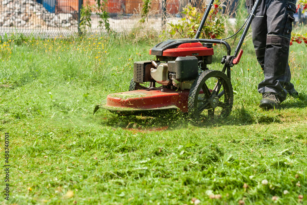 Mowing the grass with a lawn mower