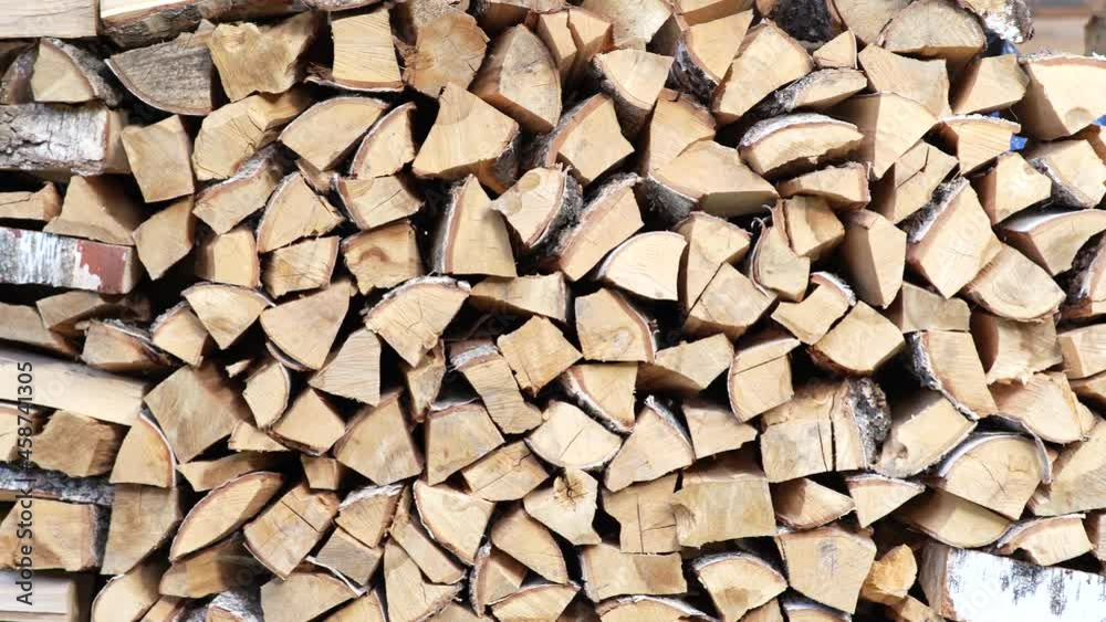 Preparation of firewood for the winter for the stove and bath. Pile of wood, a view of huge stacks of logs. Rural life. Preparation of firewood for the winter for the stove and bath. Pile of wood, a view of huge stacks of logs. Rural life.