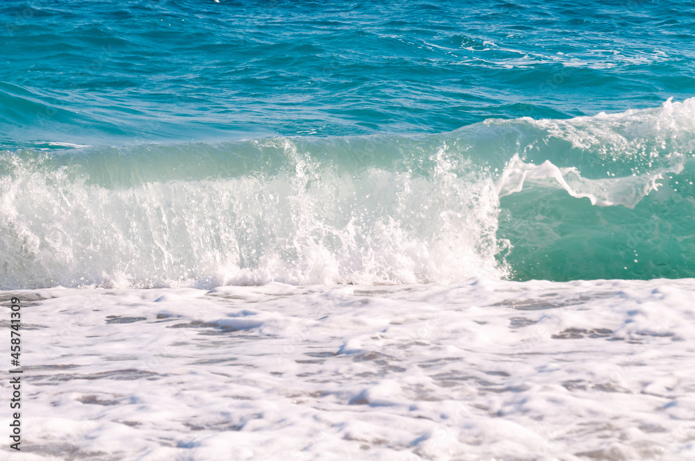 beautiful surf waves near the sandy beach on a clear summer da?