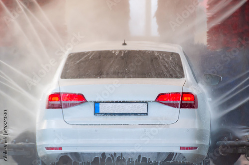 the car is washed in an automatic car wash with brushes