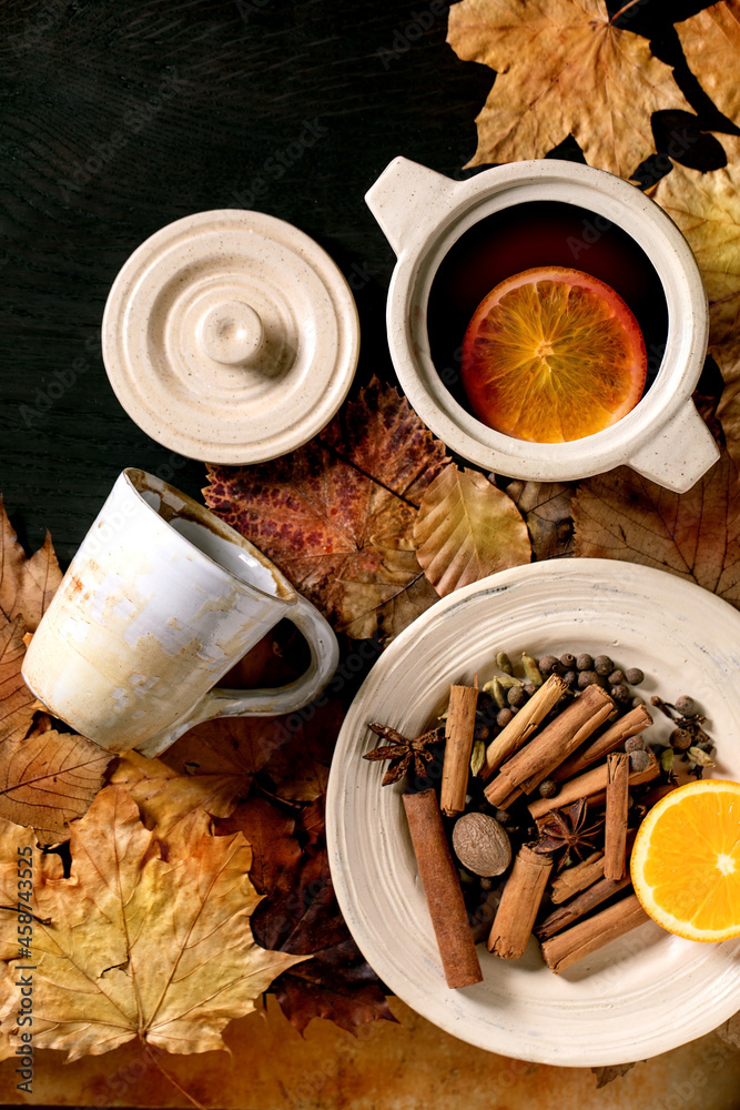 Hot mulled wine with spices and autumn leaves Hot mulled wine with spices and autumn leaves