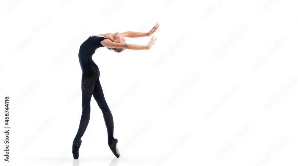 young ballerina in black pointe shoes and leotards posing in graceful pose, isolated on white background