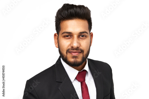 Portrait of young indian business man on white isolated background looking to the camera