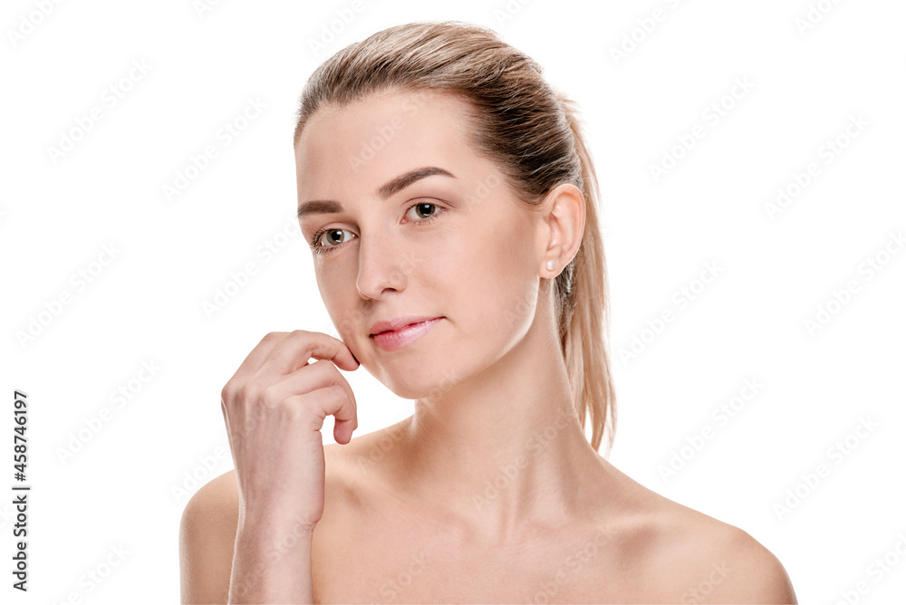 Young woman with clean fresh skin touching face after spa