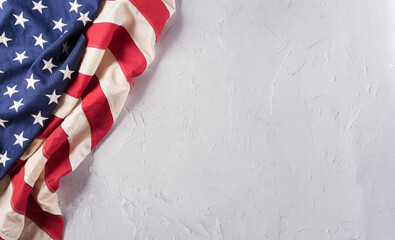 Happy Veterans Day concept. American flags against a white stone  background. November 11.