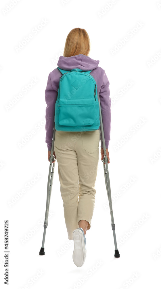 Young woman with axillary crutches on white background, back view Young woman with axillary crutches on white background, back view