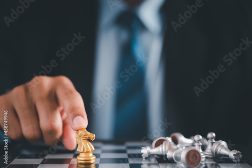 Businessman moves chess with hand.Strategic planning concept about mistakes topple the opposing team and analyze the development for the success of the organization.