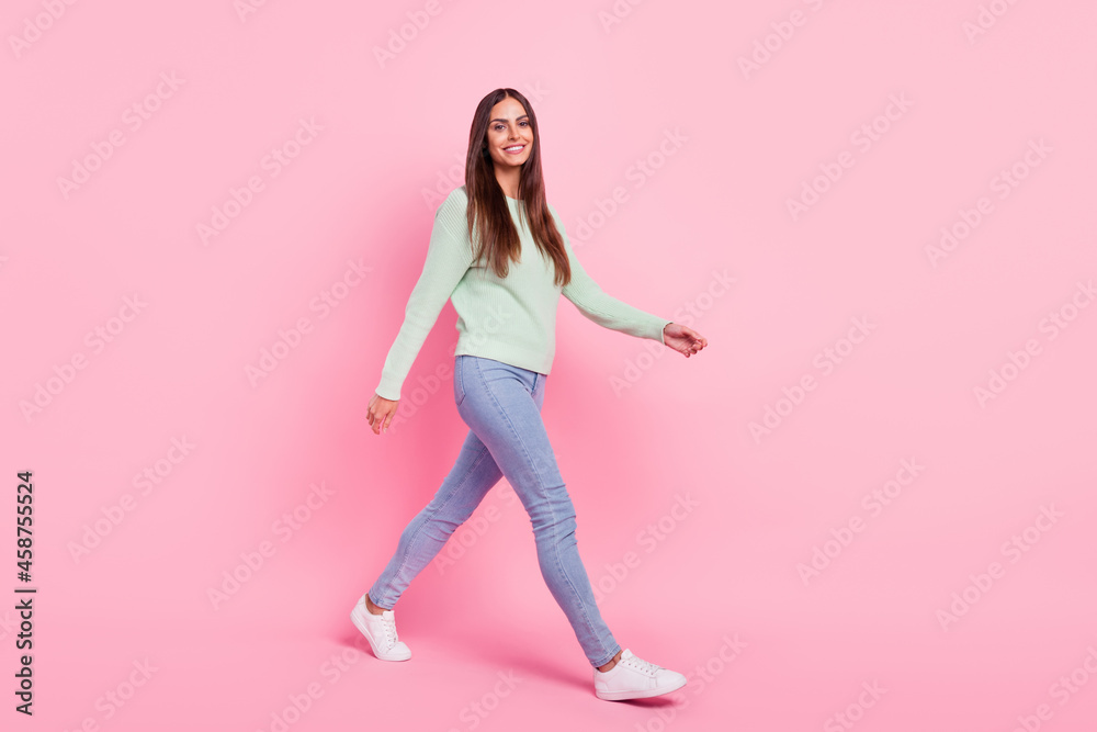 Full size profile side photo of young cheerful woman happy positive smile go walk meeting isolated over pink color background