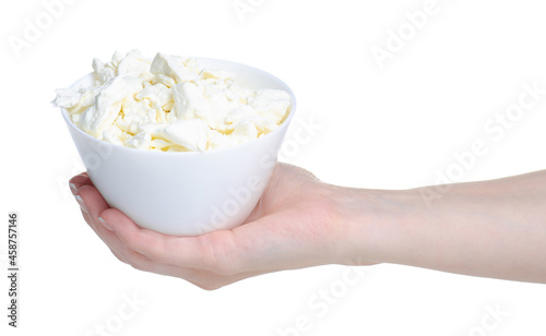 Hand holding cottage cheese in bowl on white background isolation