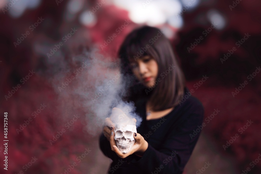 Witch girl making spooky magical in the dark forest. Asian girl with spooky dark magic at forest. Witch girl making spooky magical in the dark forest. Asian girl with spooky dark magic at forest.