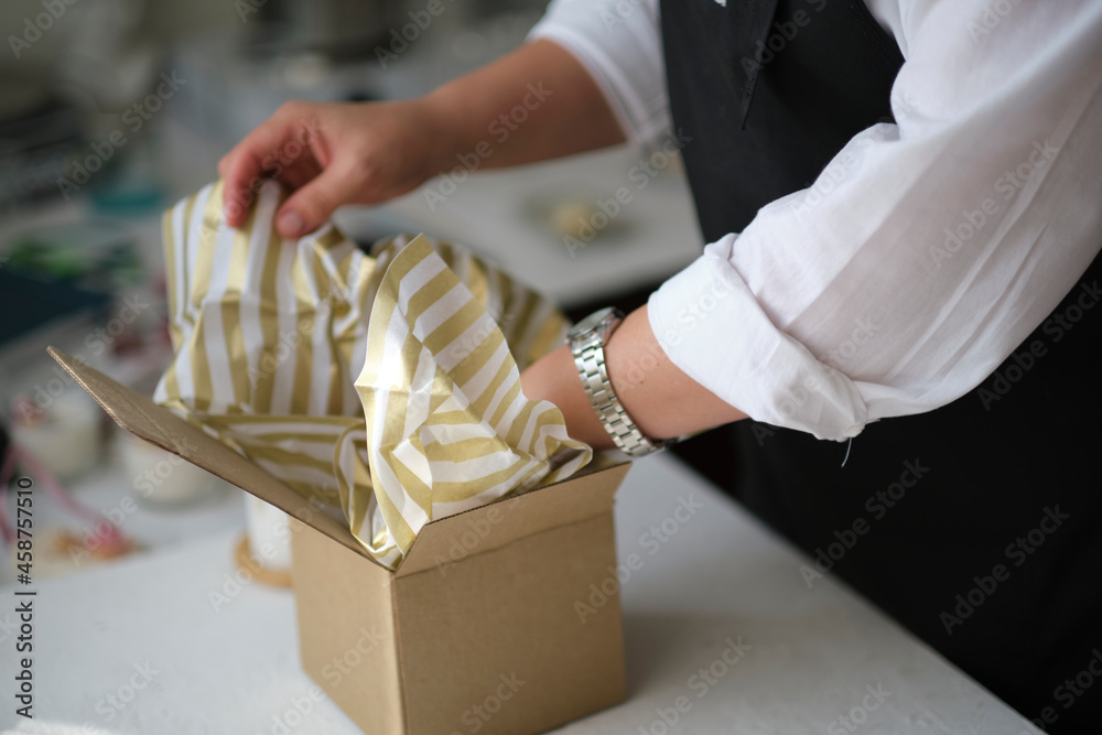 Obraz premium small business owner, online marketing packaging box and delivery. A parcel wrapped in brown paper. Delivery concept for private companies delivery with care. Craft present box