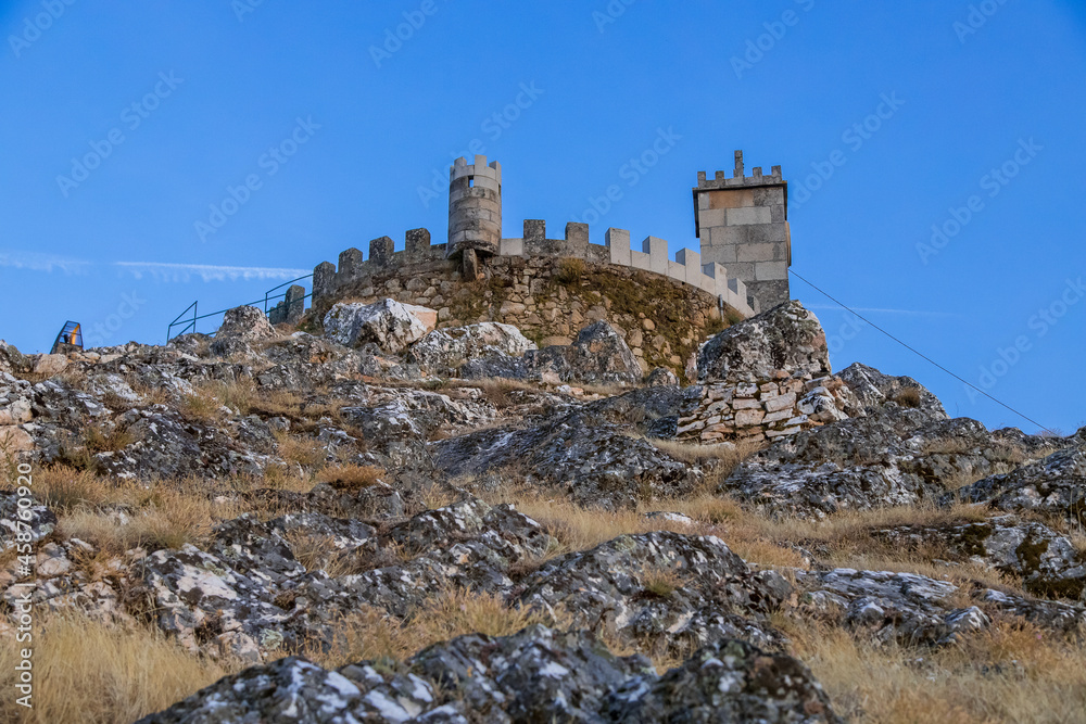 The tower of the castle. Exterior view of the castle in Folgosinho, Portuguese tourist village. The tower of the castle. Exterior view of the castle in Folgosinho, Portuguese tourist village.