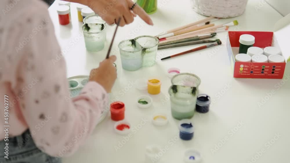 A working process of kids painting in the modern art school A working process of kids painting in the modern art school