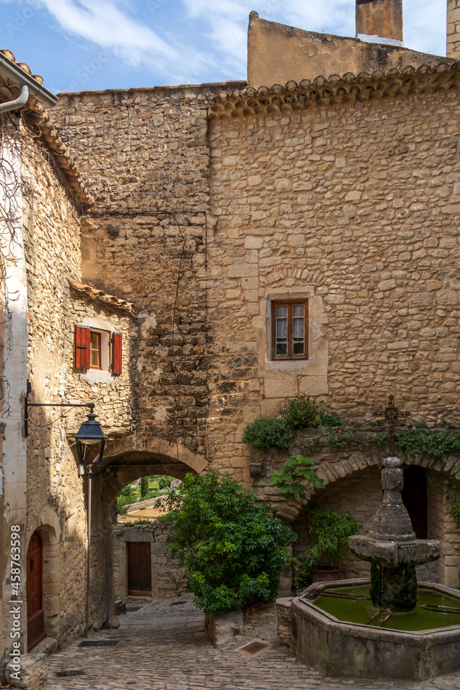 Crestet narrow street of typical provencal old town, medieval village in Vaucluse, France, Europe