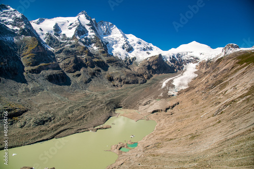 Grossglockner Pasterze Glacier and lake underneath, beautiful summer landscape with blue sky and mpuntains covered by snow. photo