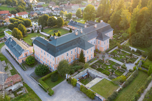 Representative pink rococo Nove Hrady castle from 1777, french garden, village near Litomysl, Pardubice region, Czech republic. Aerial view, summer time.