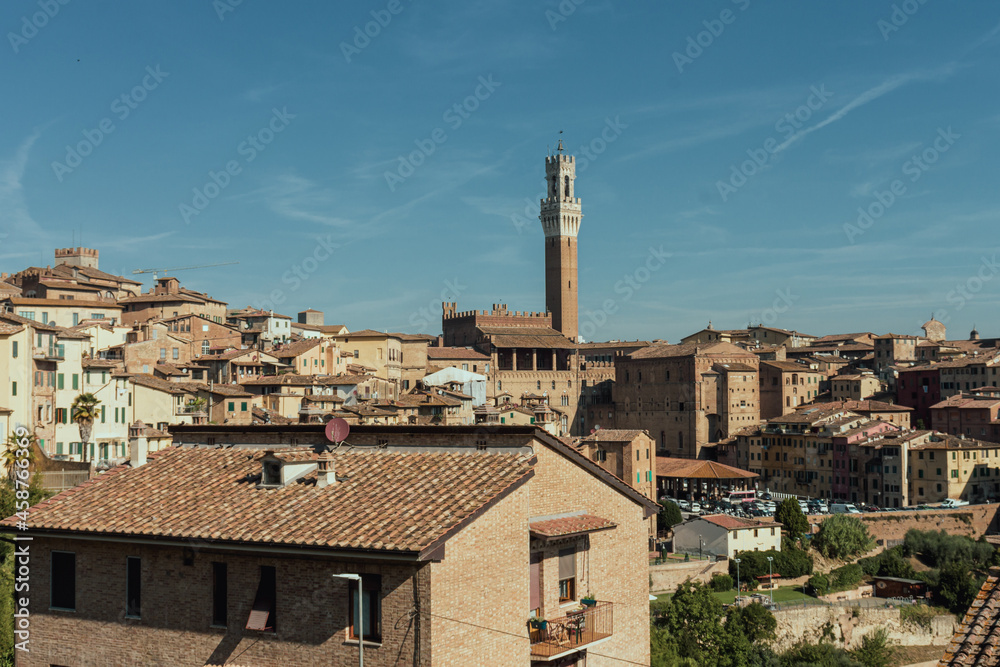 High angle view of the city of Siena. In the backgorund: Torre del Mangia (Mangia tower). Tuscany, Italy