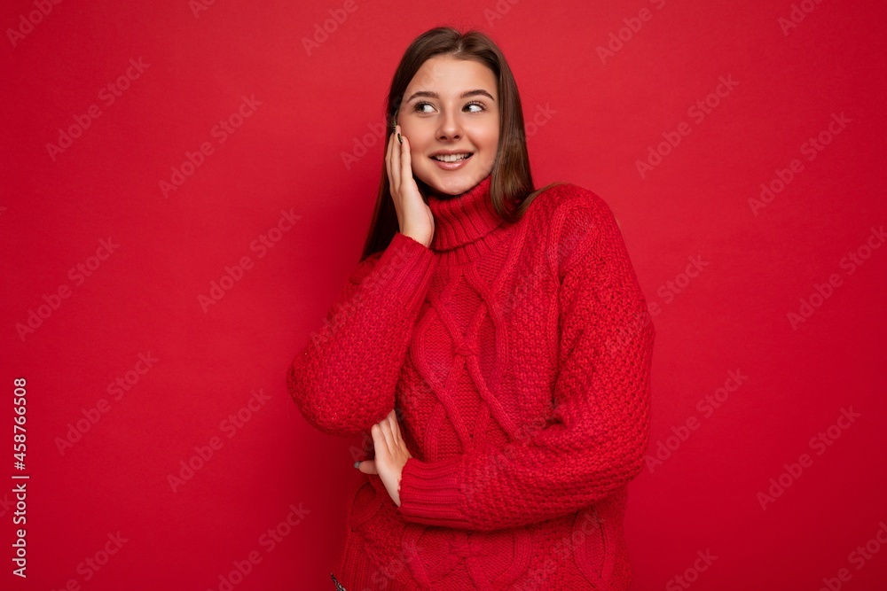 Shot of attractive happy smiling young woman wearing casual outfit standing isolated over colourful background with empty space looking to the side Shot of attractive happy smiling young woman wearing casual outfit standing isolated over colourful background with empty space looking to the side
