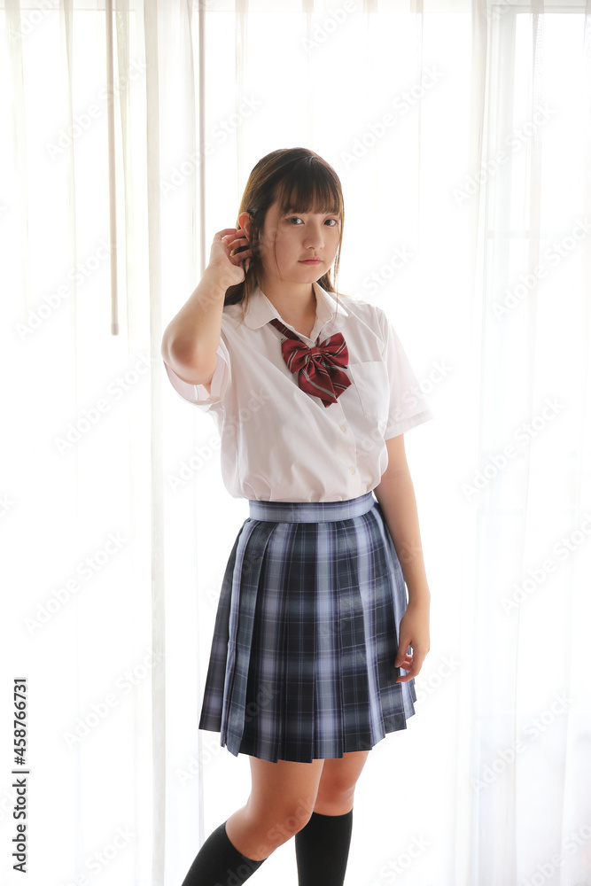 Portrait japanese school girl uniform in white tone bed room Portrait japanese school girl uniform in white tone bed room