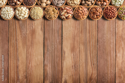 assorted nuts and seeds on rustic table, organic food background with empty space