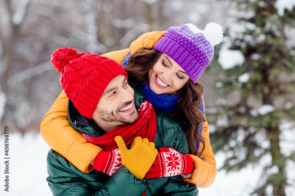 Photo of sweet pretty girlfriend boyfriend dressed vests smiling cuddling having fun enjoying walking snow outdoors forest