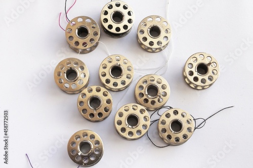 sewing machine steel yarn, bobbin for thread on white background