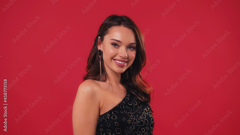 cheerful and elegant woman smiling isolated on red. cheerful and elegant woman smiling isolated on red.