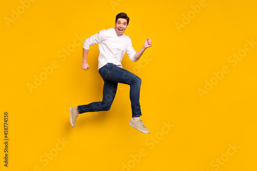 Full length body size photo man jumping up running on sale isolated vivid yellow color background