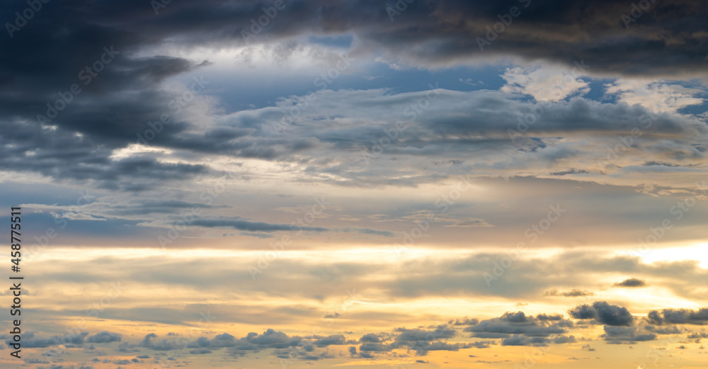 Evening sky with bright sunlight and dark blue clouds Evening sky with bright sunlight and dark blue clouds