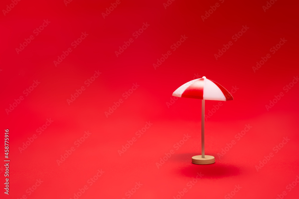 Red umbrella on a red background.