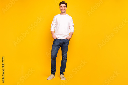 Full length body size photo brunet guy in casual outfit smiling confident isolated vibrant yellow color background