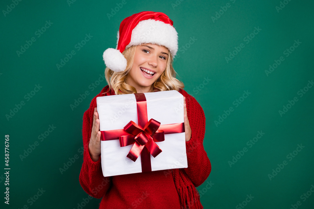 Photo of young girl happy positive smile hold gift box winter season eve time isolated over green color background Photo of young girl happy positive smile hold gift box winter season eve time isolated over green color background