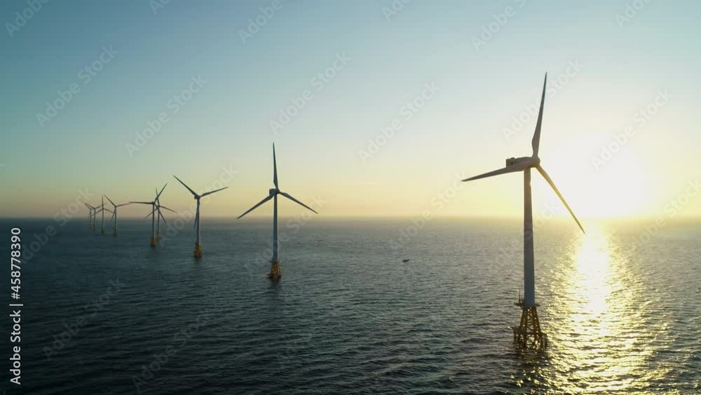 Beautiful sunset background the wind power generators on the sea, Offshore wind turbine in Jeju Island. South Korea. 제주 해안 풍력발전, 해상풍력, 바다, 풍력발전기