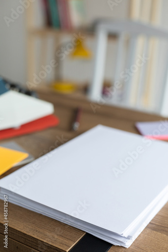 Sheet of paper on wood desk table. Office or study creative concept