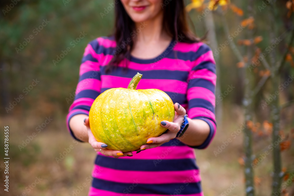 faceless woman holds with pumpkin in the autumn forest. halloween concept faceless woman holds with pumpkin in the autumn forest. halloween concept