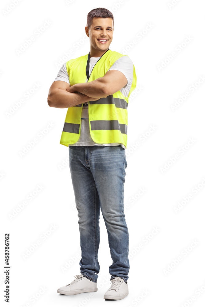 Full length portrait of a smiling security officer in a safety vest standing with crossed arms Full length portrait of a smiling security officer in a safety vest standing with crossed arms