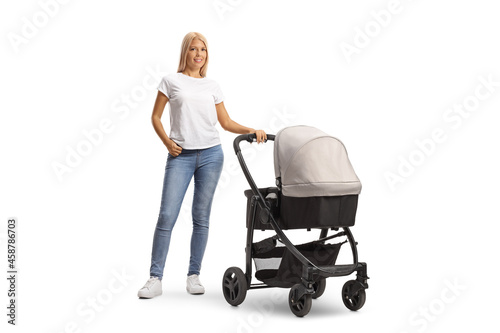 Schilderij op canvas Full length portrait of a young woman in jeans with a pushchair