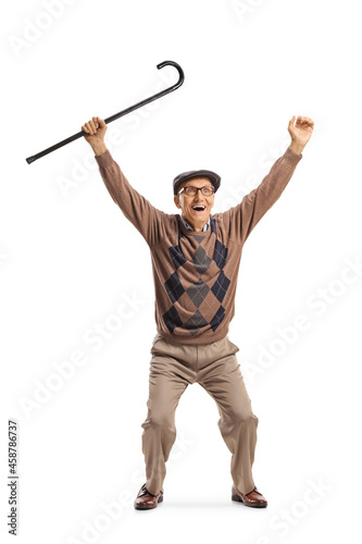 Full length portrait of a happy elderly man lifting a cane up