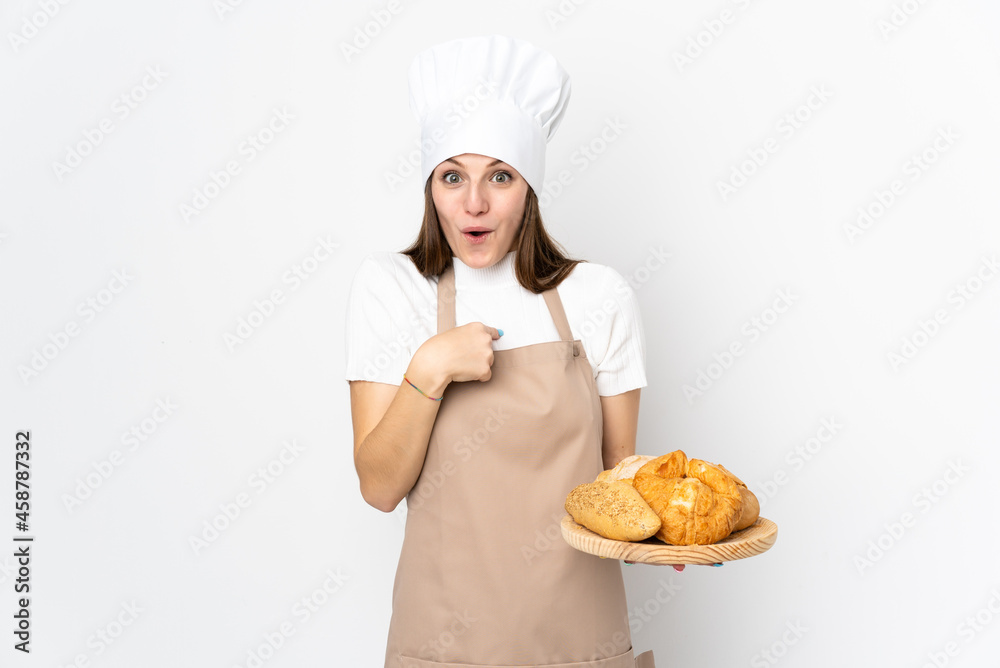 Young woman in chef uniform isolated on white background with surprise facial expression Young woman in chef uniform isolated on white background with surprise facial expression