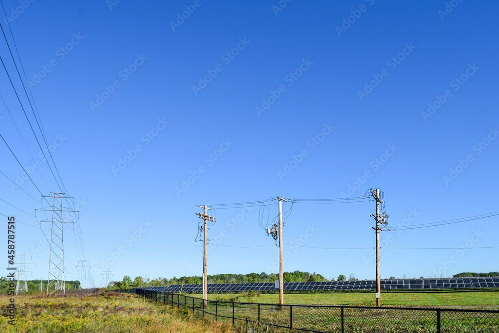 Fotka „Solar panels, high voltage power lines and telephone lines in a