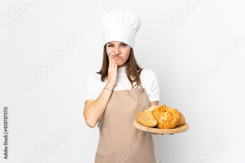 Young woman in chef uniform isolated on white background unhappy and frustrated