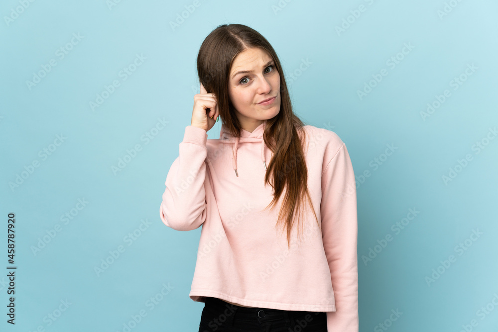 Young caucasian woman isolated on blue background having doubts Young caucasian woman isolated on blue background having doubts