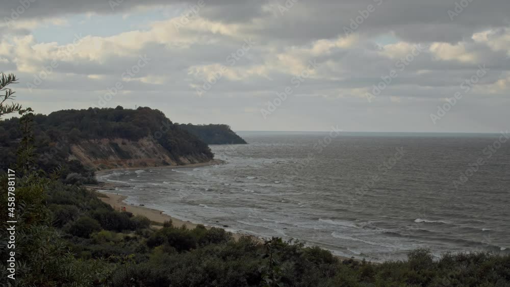 Top view shot, overlooking at Philins bay on a cloudy cold day, in Kaliningrad area, Russia. Panoramic view of cliffs surrounding a bay of water on a cloudy day Top view shot, overlooking at Philins bay on a cloudy cold day, in Kaliningrad area, Russia. Panoramic view of cliffs surrounding a bay of water on a cloudy day