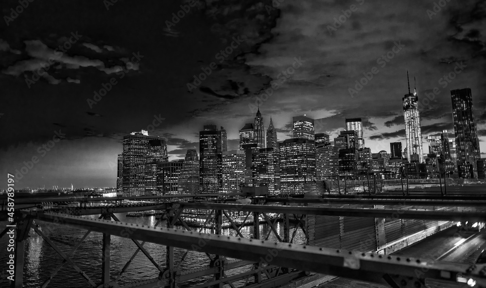 Brooklyn Bridge and car traffic at night, New York City.