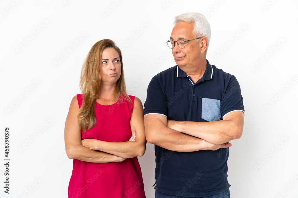 Middle age couple isolated on white background annoyed angry in furious gesture Middle age couple isolated on white background annoyed angry in furious gesture