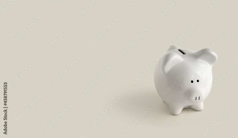 Piggy bank on green background to right side Piggy bank on green background to right side