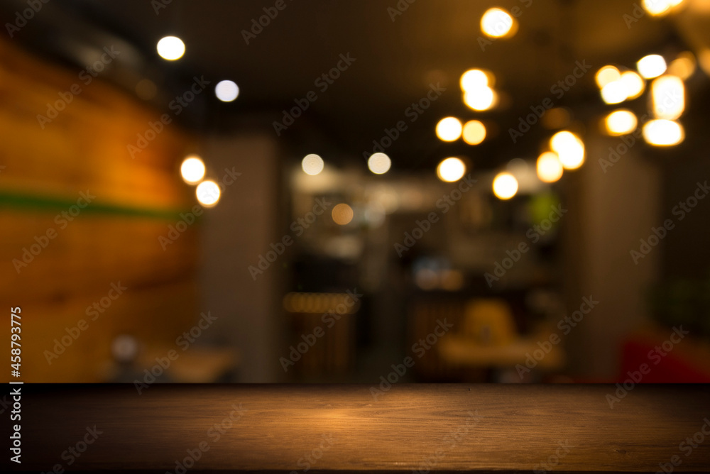 Empty dark wooden table in front of abstract blurred bokeh background of restaurant . can be used for display or montage your products.Mock up for space Empty dark wooden table in front of abstract blurred bokeh background of restaurant . can be used for display or montage your products.Mock up for space