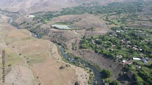 Scenic aerial drone view of Georgian canyons and Mtkvari mountain river at colorful dusk photo